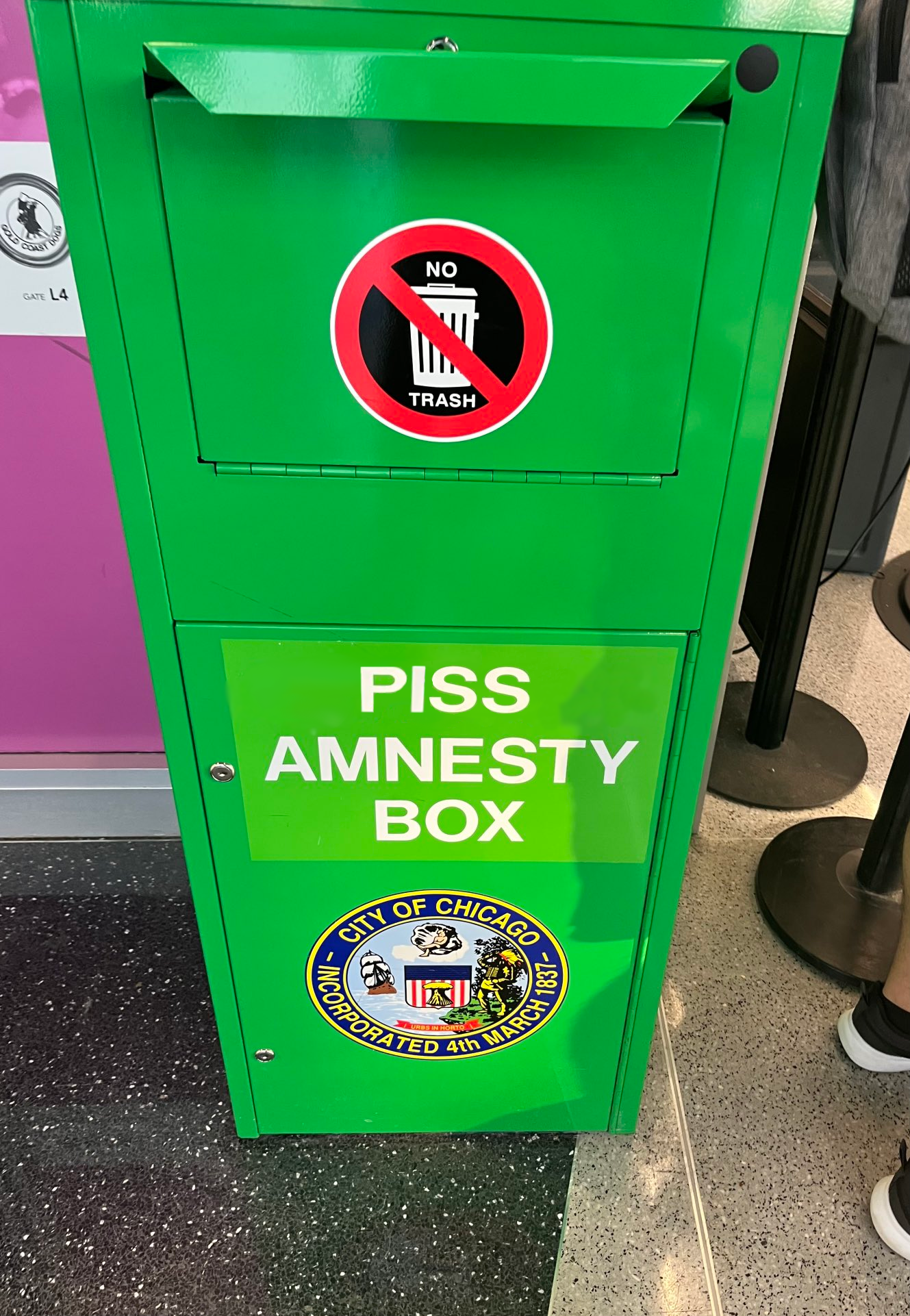 A tall green box, like those currently used for cannabis amnesty, but "Piss Amnesty" is written on the front instead of "Cannabis Amnesty"